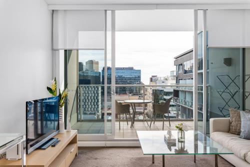 a living room with a view of a city at Swainson on Hindmarsh in Adelaide