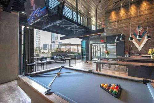 a pool table in a room with a bar at Opulence is a way of life in Dallas