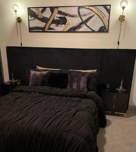 a bedroom with a large bed with purple pillows at Opulence is a way of life in Dallas