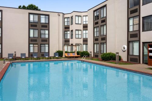 a swimming pool in front of a building at Delta Hotels by Marriott Allentown Lehigh Valley in Fogelsville
