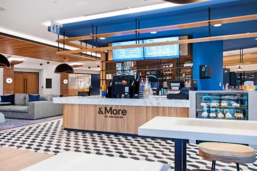 a lobby of a more restaurant with a counter at Sheraton Chapel Hill in Chapel Hill