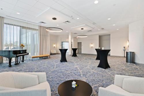 a large room with a piano and a table at Sheraton Chapel Hill in Chapel Hill