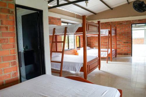 two bunk beds in a room with a brick wall at Villa Santho 