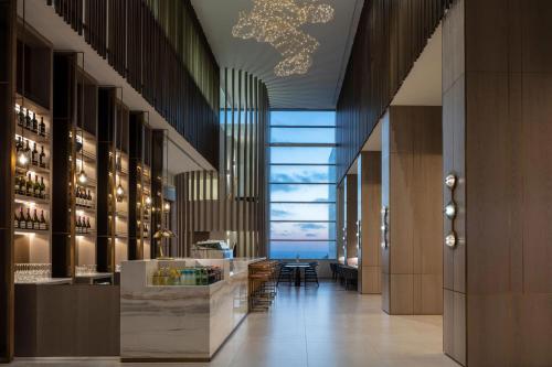 a lobby with a bar with a view of the ocean at Sheraton Grand Tel Aviv in Tel Aviv