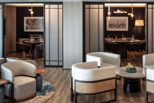 a restaurant with chairs and tables and a bar at Sheraton Grand Tel Aviv in Tel Aviv