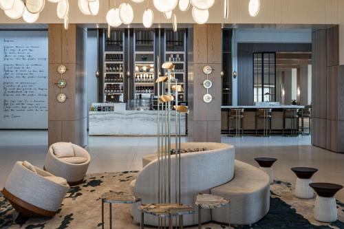 a lobby with a couch and chairs and a table at Sheraton Grand Tel Aviv in Tel Aviv