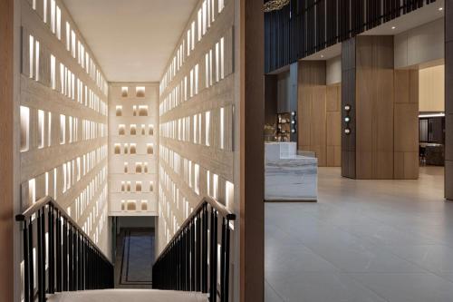 a lobby with a staircase in a building at Sheraton Grand Tel Aviv in Tel Aviv