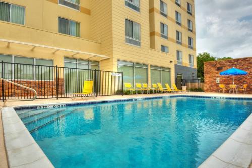 a swimming pool in front of a building at Fairfield Inn & Suites by Marriott Austin San Marcos in San Marcos