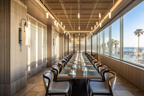 a long dining room with a long table and chairs at Sheraton Grand Tel Aviv in Tel Aviv