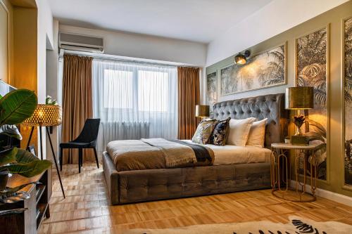 a bedroom with a bed and a couch at Designer Flat for 4, Heart of Bucharest, Kitchen in Bucharest