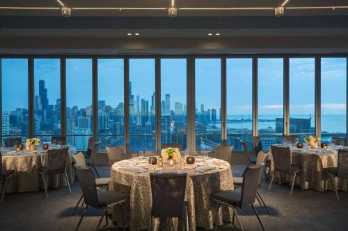 a room with tables and chairs with a view of the city at Marriott Marquis Chicago in Chicago