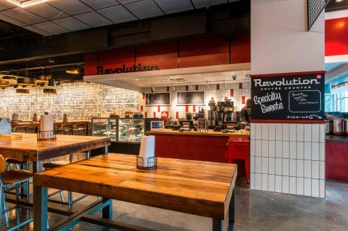 a restaurant with wooden tables in front of a kitchen at Marriott Marquis Chicago in Chicago