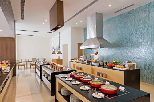a kitchen with a buffet of food on display at Fairfield by Marriott Coimbatore in Coimbatore