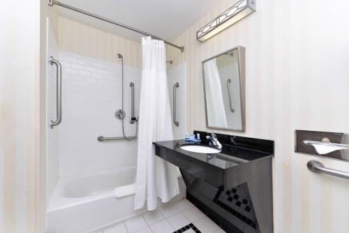 a bathroom with a sink and a tub and a shower at Fairfield Inn & Suites Kingsland in Kingsland