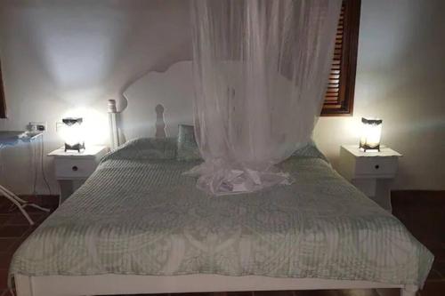 a bedroom with a large bed with two night stands at $1MIL Luxury Villa PITON VIEW - Colombette Villa in Soufrière