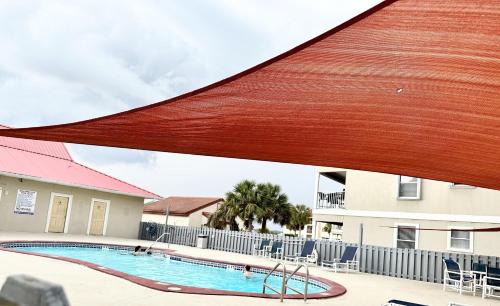 a pool at a hotel with a red roof at Emerald Hideaway condo in Navarre
