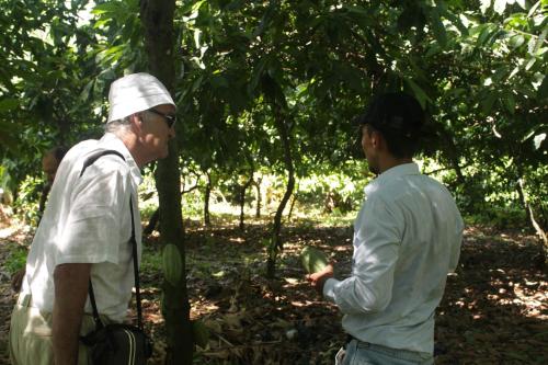 two men standing in a forest talking to each other at Puerto Barillas in Bahia de Jiquilisco