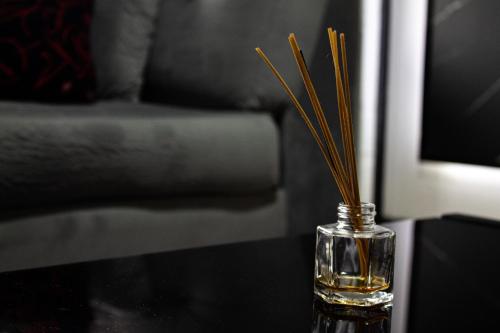 a glass vase filled with oil on a table at Hotel Gran Luna in Puerto Montt