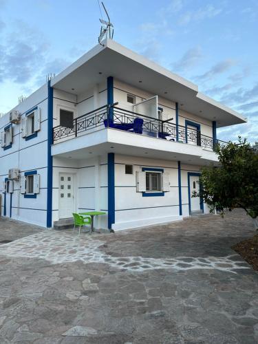 a building with a green chair in front of it at Vila Kylie in Ksamil