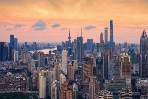 a view of a large city at sunset at The St. Regis Shanghai Jingan in Shanghai