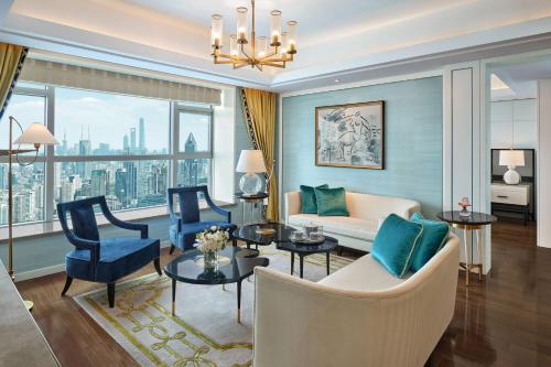 a living room with a couch and chairs at The St. Regis Shanghai Jingan in Shanghai