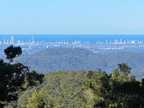 a view of a city from the top of a hill at Three Pines House - Unique Tiny House with Views in Mount Tamborine