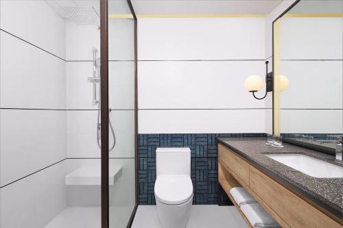 a bathroom with a toilet and a sink at Four Points by Sheraton Batam in Nagoya