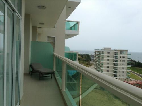 a balcony with a chair and a view of the ocean at Hotel,Căn Hộ Mũi Né Sea link in Phan Thiet