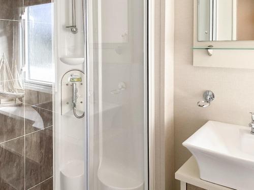 a bathroom with a shower and a sink at Ballagan Lodge in Leanach