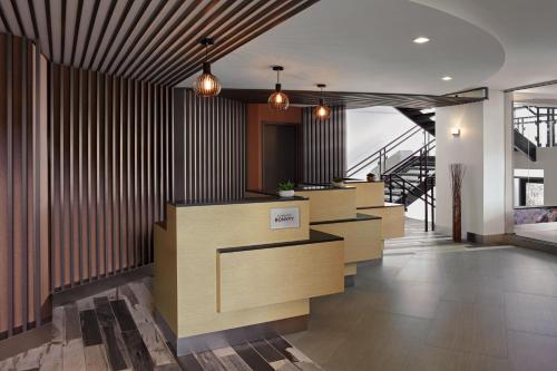 a lobby with a row of counters and a staircase at Delta Hotels by Marriott Sherbrooke Conference Centre in Sherbrooke