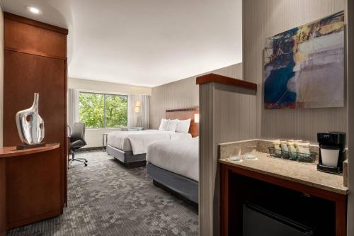 a hotel room with a bed and a fireplace at Courtyard by Marriott Philadelphia Montgomeryville in North Wales