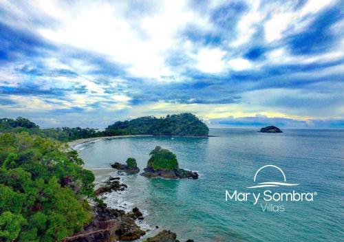 an island in the middle of a body of water at Mar y Sombra Villas in Quepos