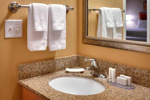 a bathroom with a sink and a mirror and towels at TownePlace Suites by Marriott Sierra Vista in Sierra Vista