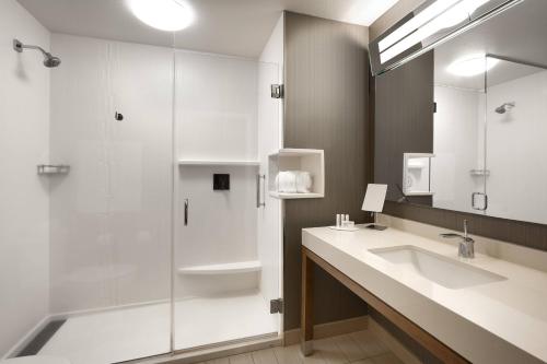 a bathroom with a sink and a shower at Courtyard by Marriott Cedar City in Cedar City