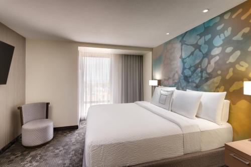 a hotel room with a large bed and a window at Courtyard by Marriott Cedar City in Cedar City