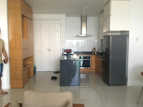 a kitchen with a black refrigerator and a stove at Hotel,Căn Hộ Mũi Né Sea link in Phan Thiet