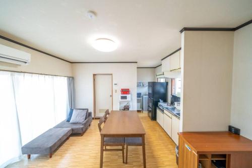 a living room with a couch and a table at コーポセキヤ / Corp Sekiya in Itoigawa