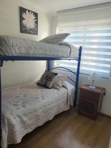 a bedroom with two bunk beds and a table at Peñuelas Club in Coquimbo