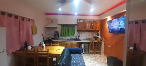 a kitchen with a table and a dining room at Alojamiento walter in Ezeiza