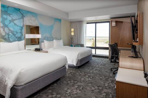 a hotel room with two beds and a large window at Courtyard Pasco Tri-Cities Airport in Pasco