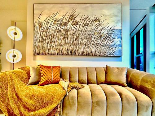 a couch in a living room with a painting at Highrise view 1king1Queen 2baths in Melbourne