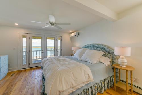 a bedroom with a bed and a ceiling fan at Brigantine Waterfront Vacation Rental with Grill in Brigantine