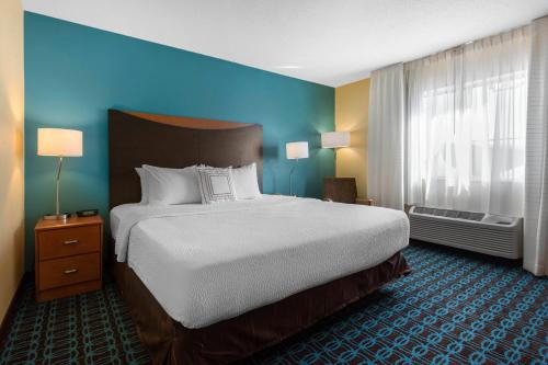 a hotel room with a large bed and a window at AmericInn by Wyndham St Cloud MN Shopping Area in Saint Cloud