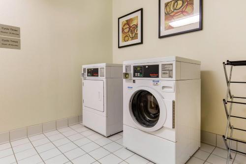 a washing machine and a dryer in a room at AmericInn by Wyndham St Cloud MN Shopping Area in Saint Cloud