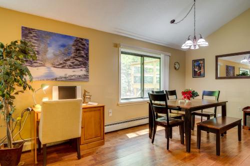 a dining room and living room with a table and chairs at Bartlett Townhome with Balcony 1 Mi to Ski Resort! in Bartlett