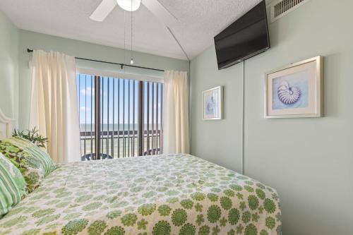 a bedroom with a bed and a large window at Cozy & Charming Oceanfront Condo #803 @ Buena Vista in Myrtle Beach