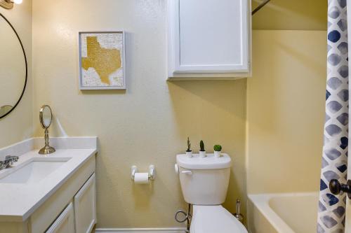 a bathroom with a white toilet and a sink at 3 Mi to Dtwn Waxahachie Townhome with Fire Pit in Waxahachie