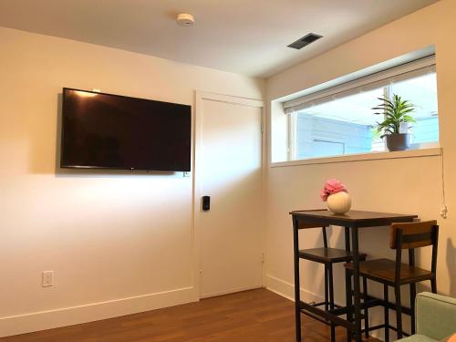 a living room with a flat screen tv on the wall at Newly Renovated Walkout Basement in Vancouver with Separate Entrance in Vancouver