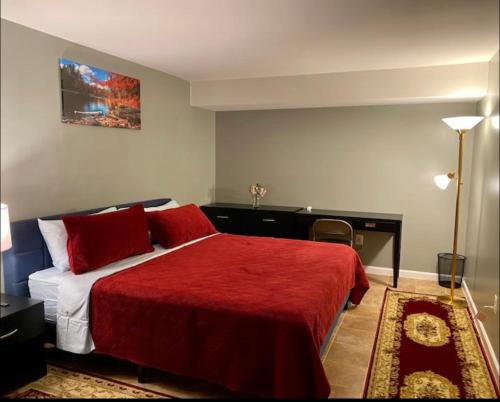 a bedroom with a red bed with a red blanket at Van Gogh Guest Rm #7 • Van Gogh 7-Private BSMT Rm in single family home in Rosedale