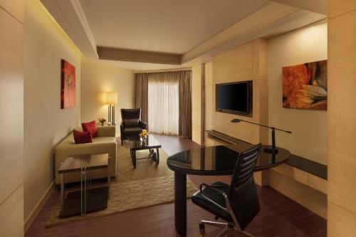 a living room with a table and a couch at JW Marriott Mumbai Juhu in Mumbai
